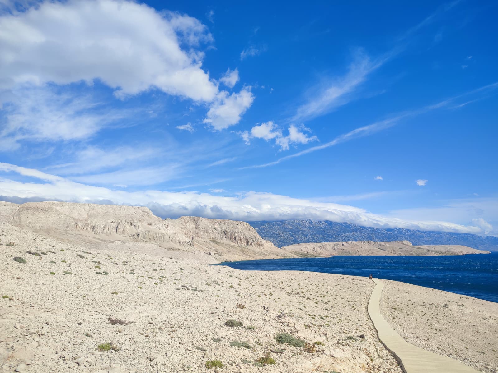 walking trail Metajna Rucica beach concrete path Pag island Croatia
